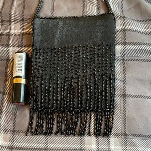 After 5 Crossbody Shoulder Bag sparkles & has fringes with a magnetic closure